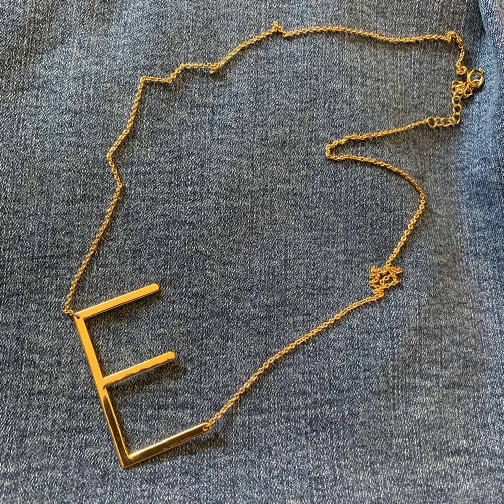 E gold toned necklace
